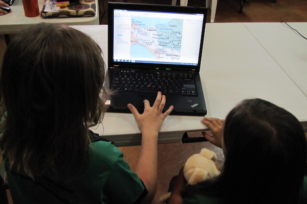 Second graders do GIS in bi-lingual classroom. (Note stuffed animal in arm.)
