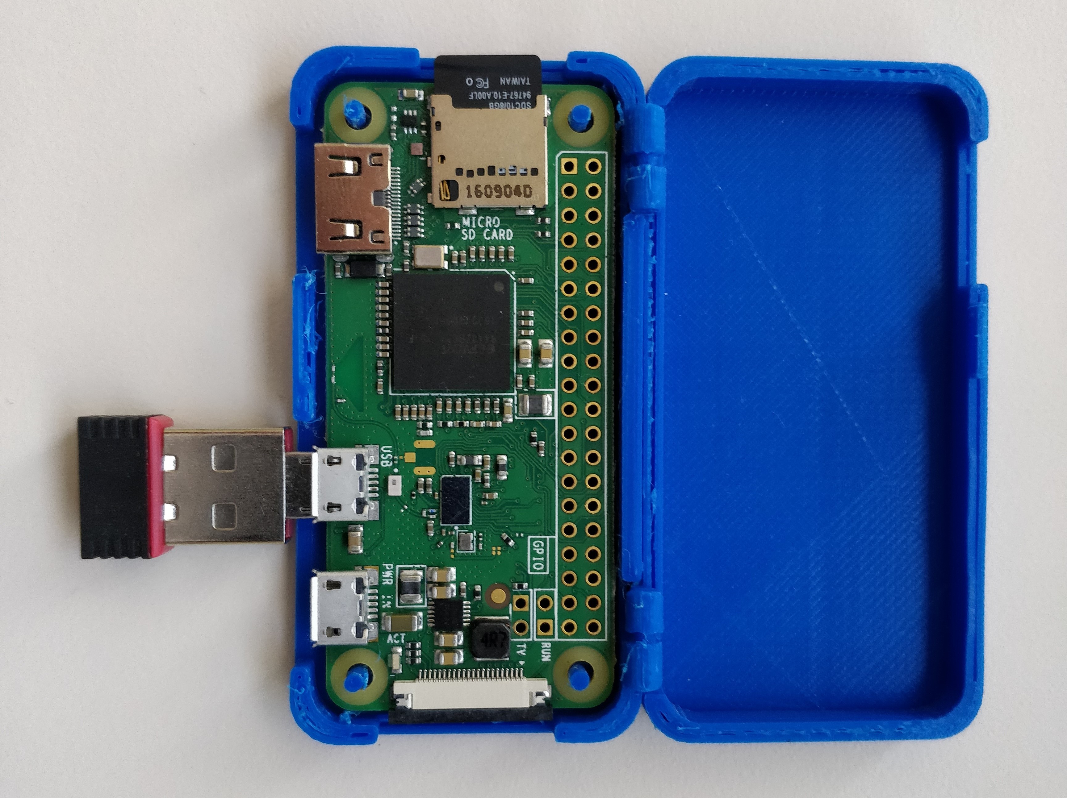 Blue box open with Raspberry Pi board exposed.