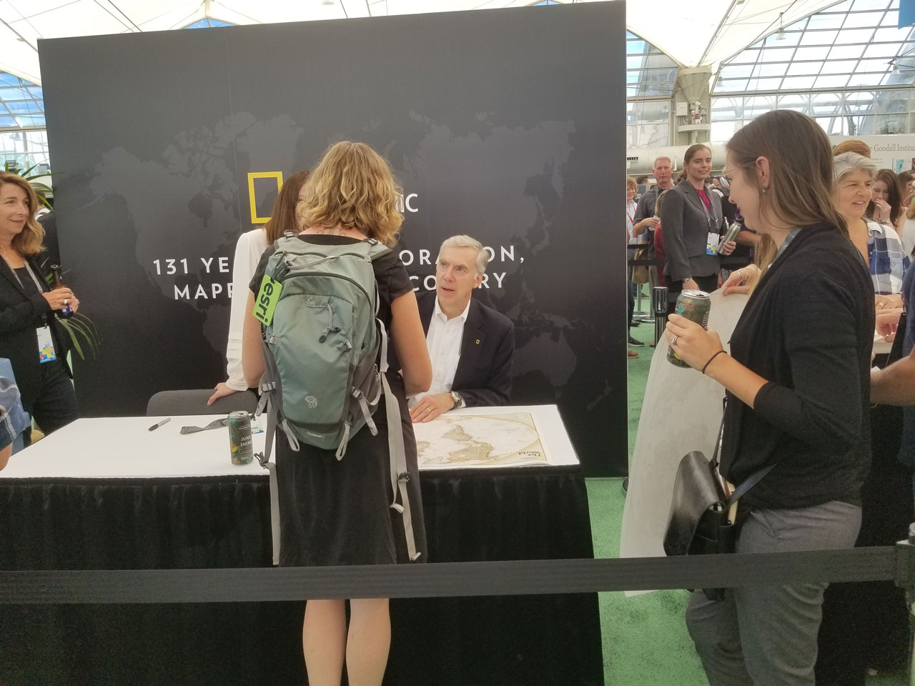 Tracy R. Wolstencraft of the National Geographic Society was at the National Geographic booth signing posters.
